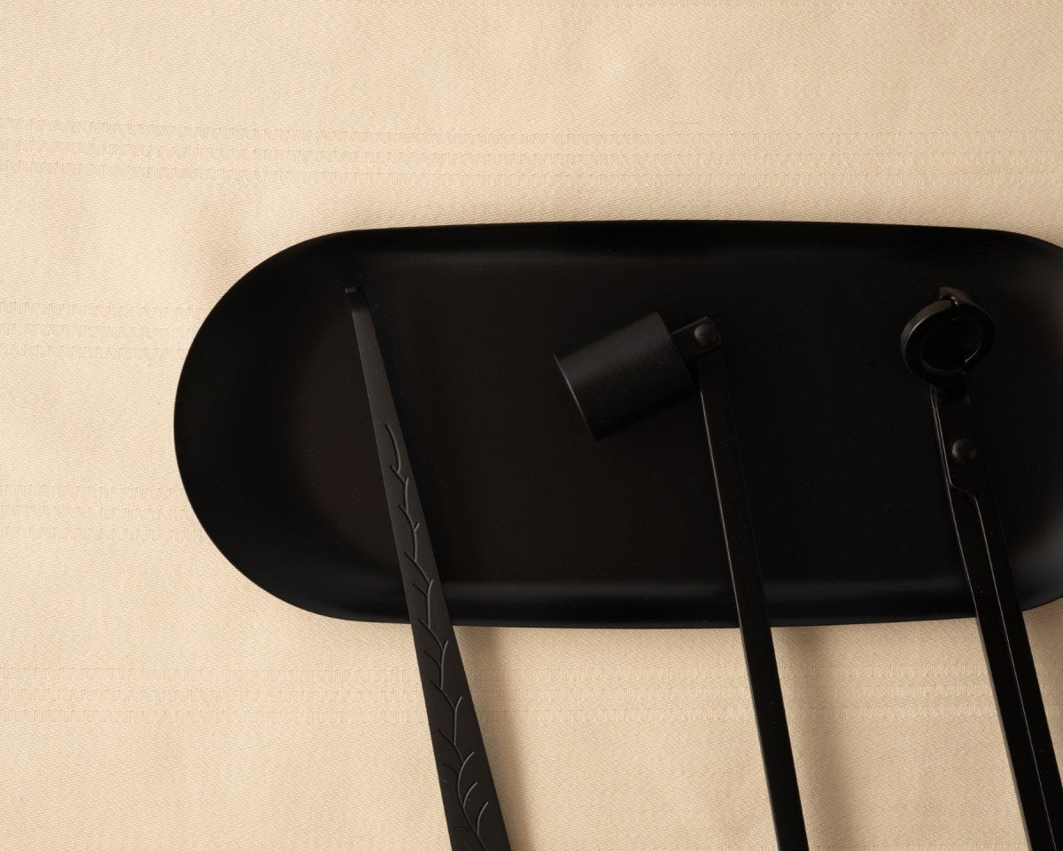 Black Candle Care Accessories Set on a tan background.