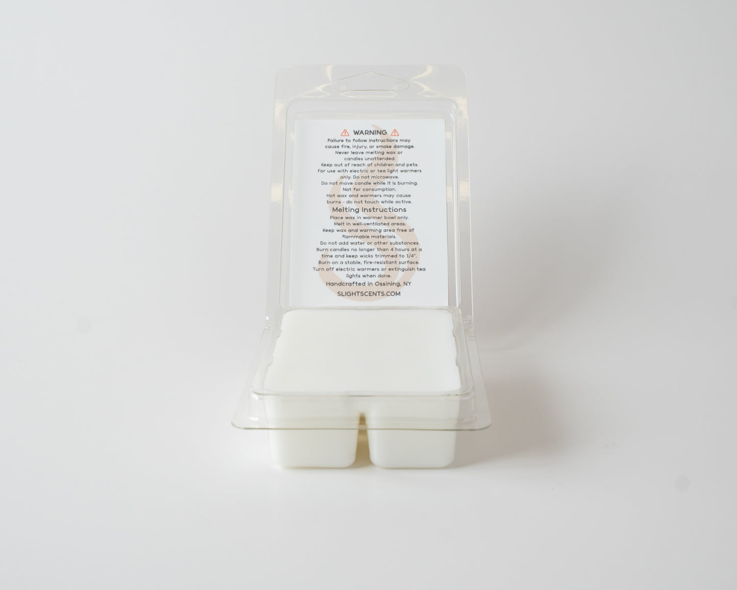 Aged Mahogany wax melt on a white background. Open clam shell container.