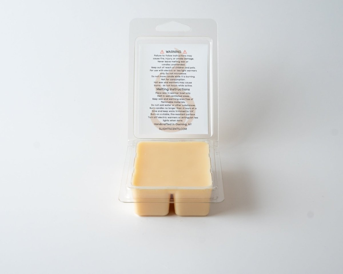 Cocoa Butter Vanilla wax melt on a white background. Open clam shell container.