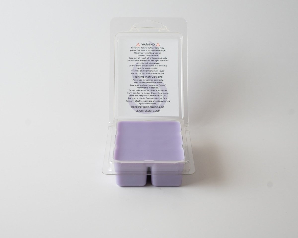 Gentle Sage & Lavender wax melt on a white background. Open clam shell container.