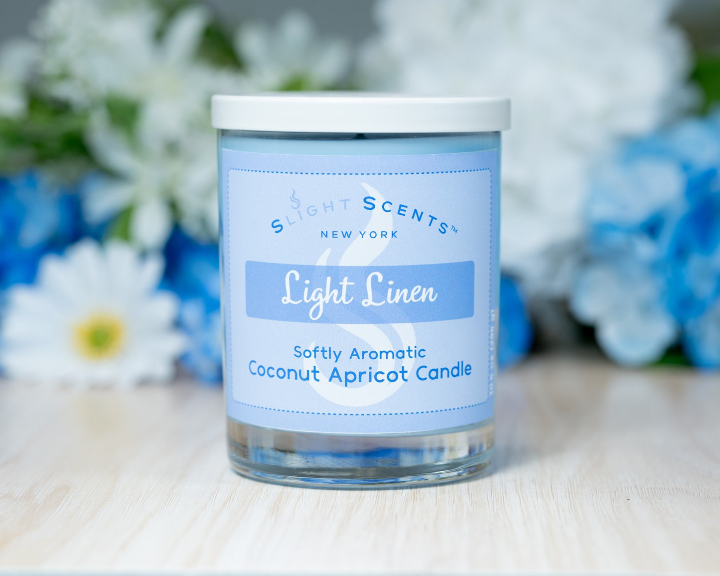 Slight Scents candle labeled 'Light Linen' with a floral background