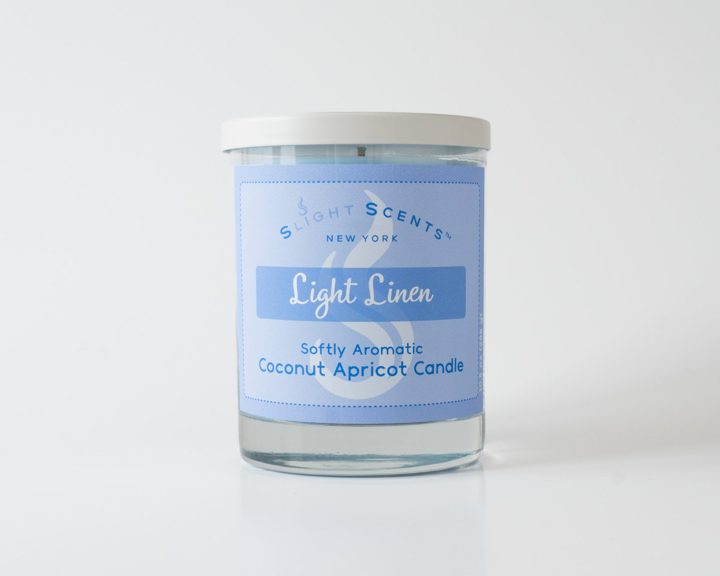 Light Linen Softly Aromatic Coconut Apricot Candle by Slight Scents New York against a white background.