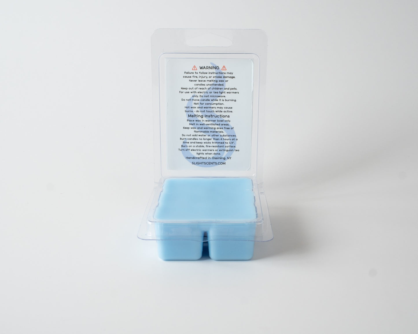 Light Linen wax melt on a white background. Open clam shell container.