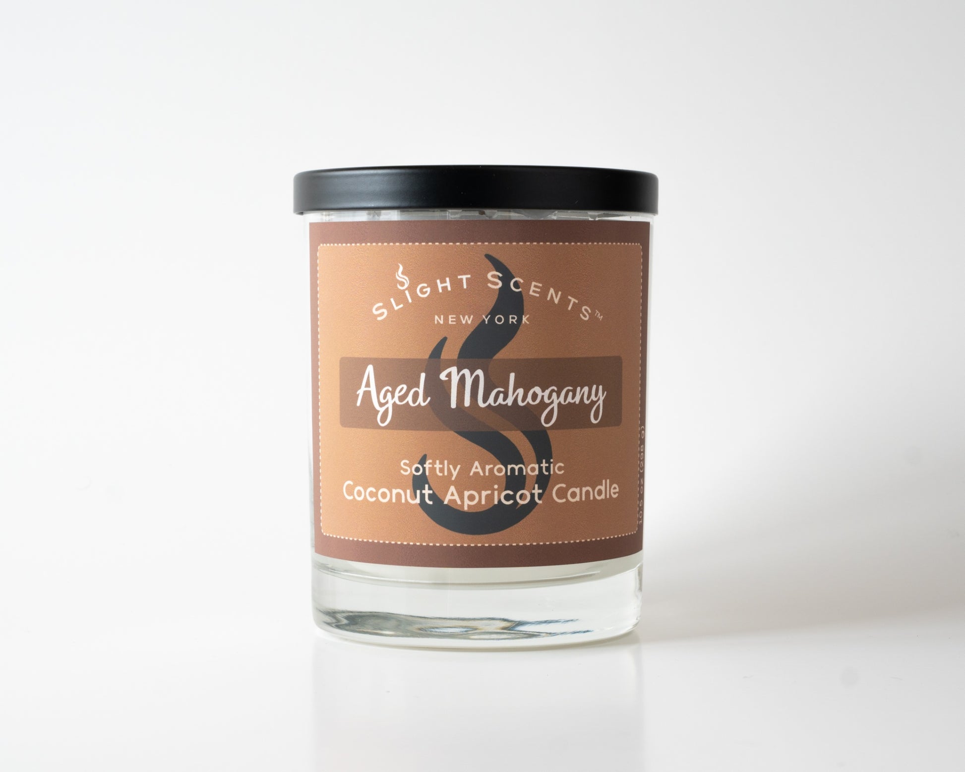 Aged Mahogany Softly Aromatic Coconut Apricot Candle by Slight Scents New York against a white background.