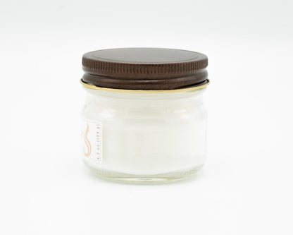 Coconut Apricot Candle in a 4.5oz mason jar. Side view.
