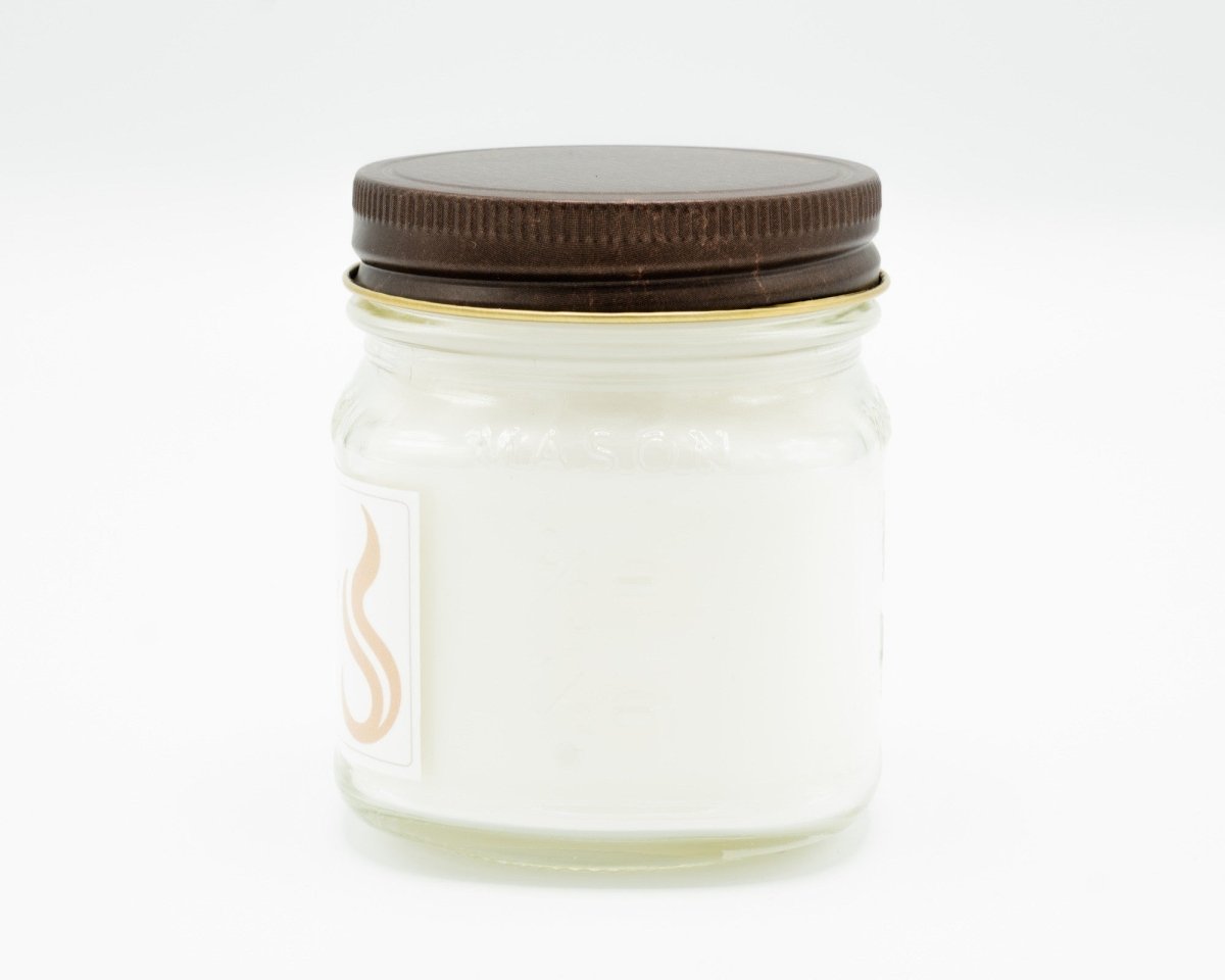 Aged Mahogany Coconut Apricot Candle in a 8oz mason jar. Side view.