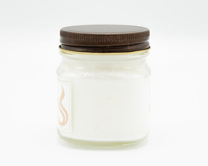 Aged Mahogany Coconut Apricot Candle in a 8oz mason jar. Side view.