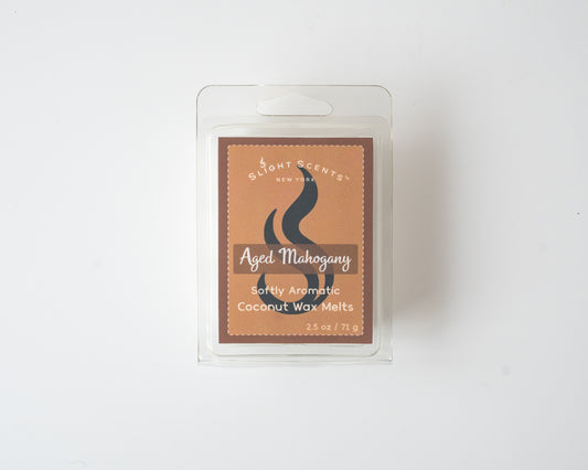 Aged Mahogany wax melt on a white background. Closed clam shell container.