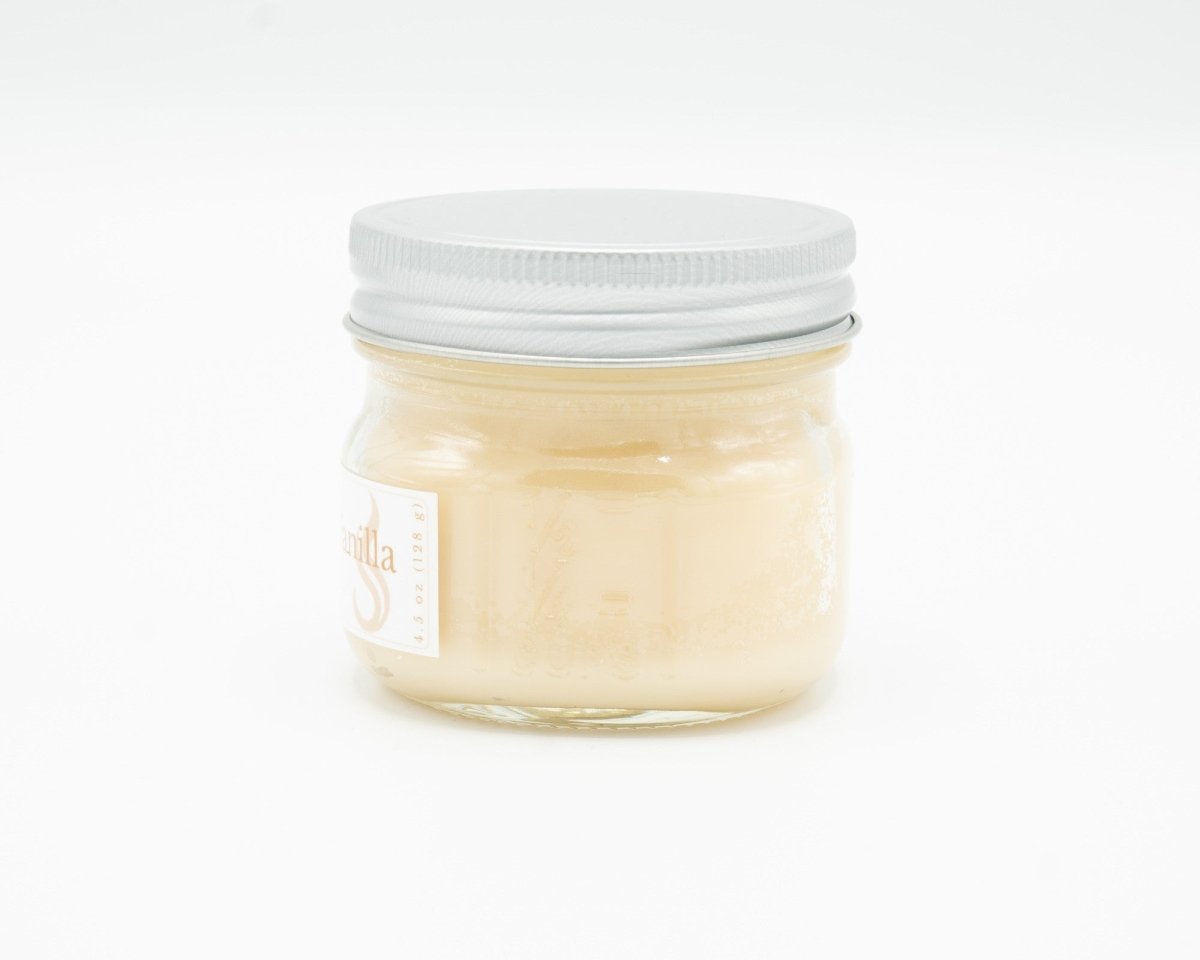 Cocoa Butter Vanilla Coconut Apricot Candle in a 4.5oz mason jar. Side view.