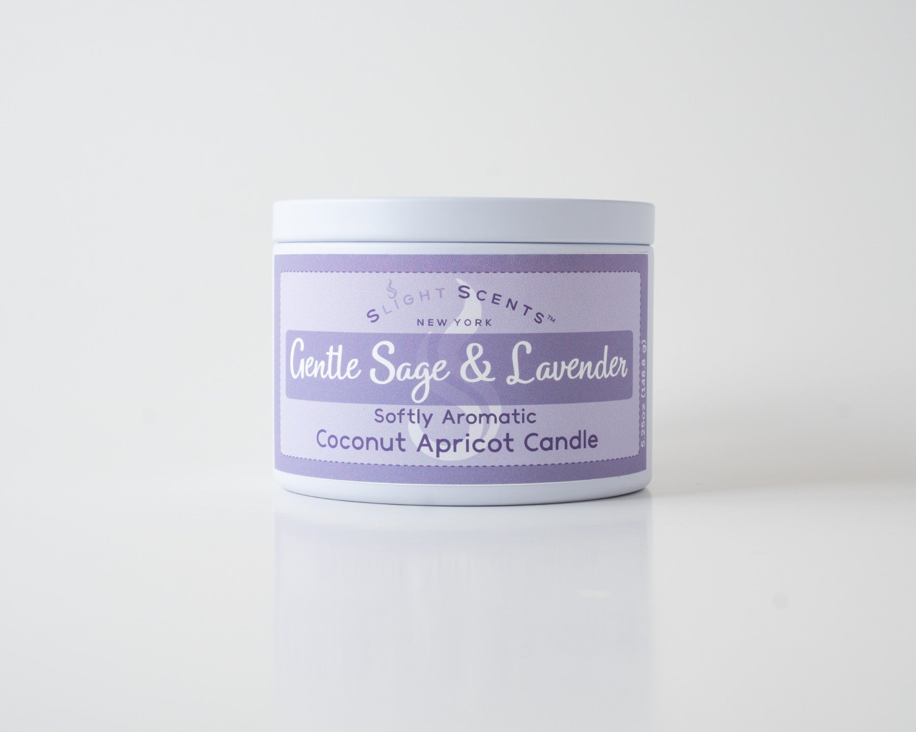 Gentle Sage & Lavender Coconut Apricot Candle By Slight Scents New York in a white metal tin on a white background.