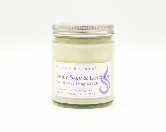 Front view of an Gentle Sage and Lavender odor neutralizing candle with white label, undyed wax, and silver metal lid in a glass jar. 