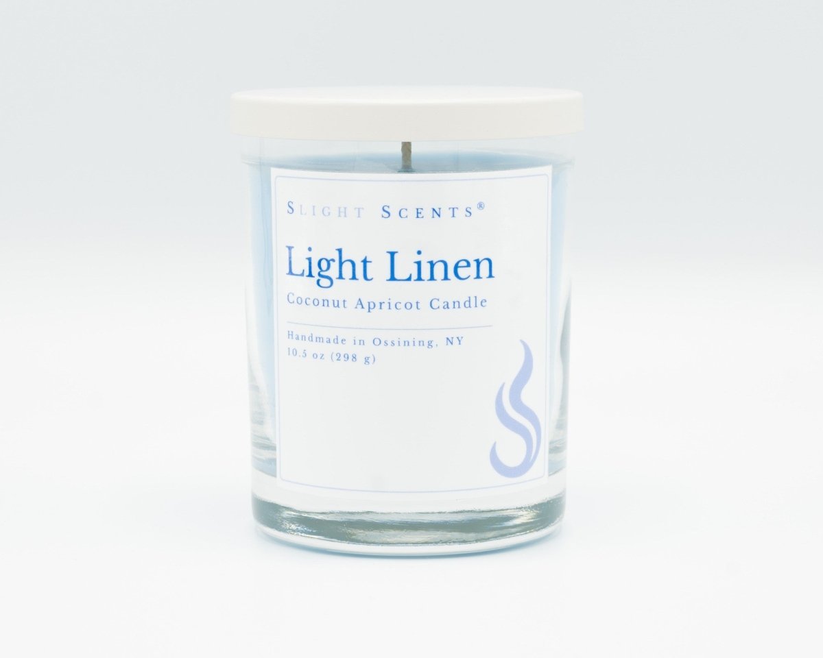 Light Linen Softly Aromatic Coconut Apricot Candle by Slight Scents New York against a white background.