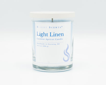 Light Linen Softly Aromatic Coconut Apricot Candle by Slight Scents New York against a white background.