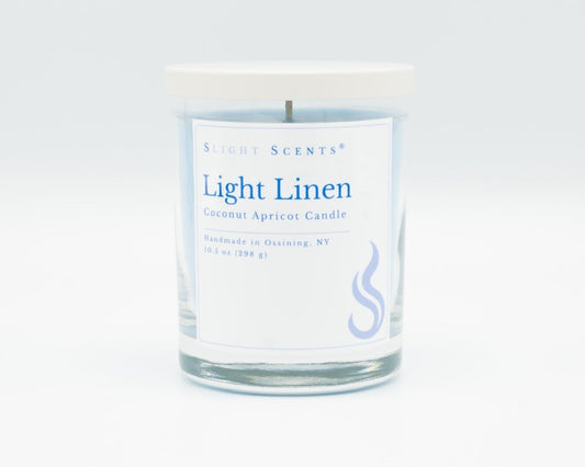 Light Linen Softly Aromatic Coconut Apricot Candle by Slight Scents New York against a white background.