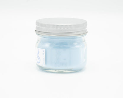 Light Linen Coconut Apricot Candle in a 4.5oz mason jar. Side view.