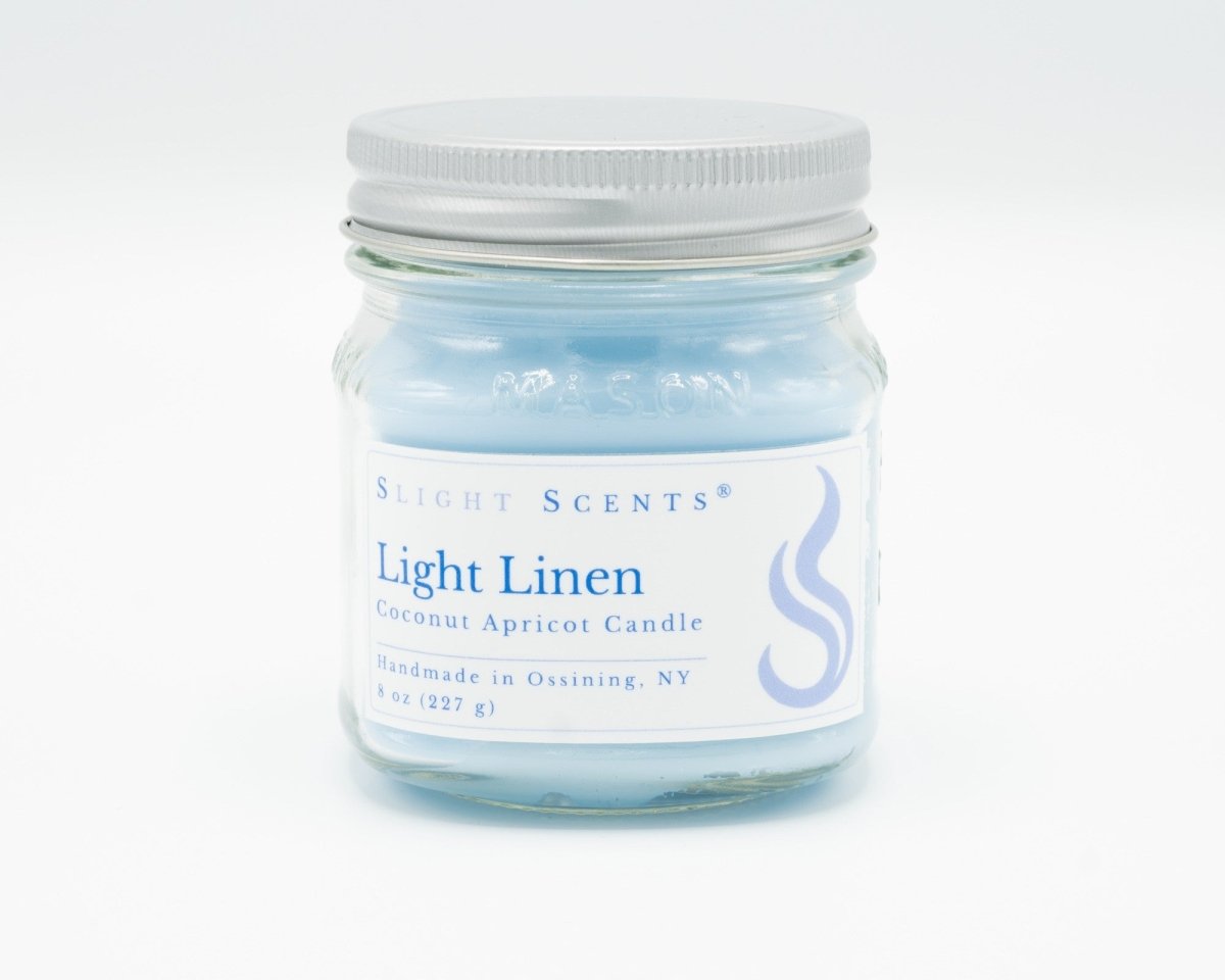 Light Linen Coconut Apricot Candle in a 8oz mason jar. Front view. 