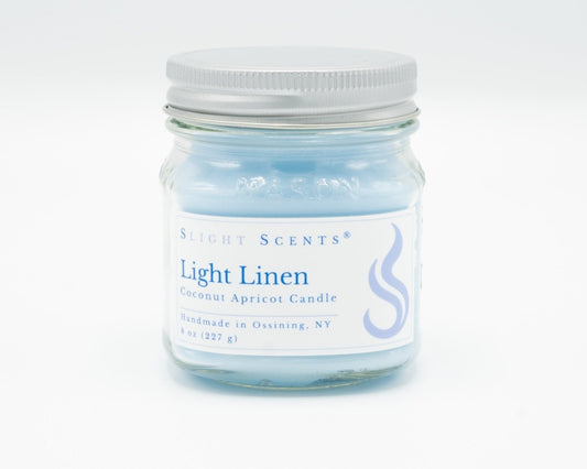 Light Linen Coconut Apricot Candle in a 8oz mason jar. Front view. 