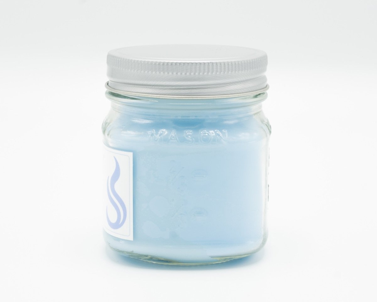 Light Linen Coconut Apricot Candle in a 8oz mason jar. Side view.
