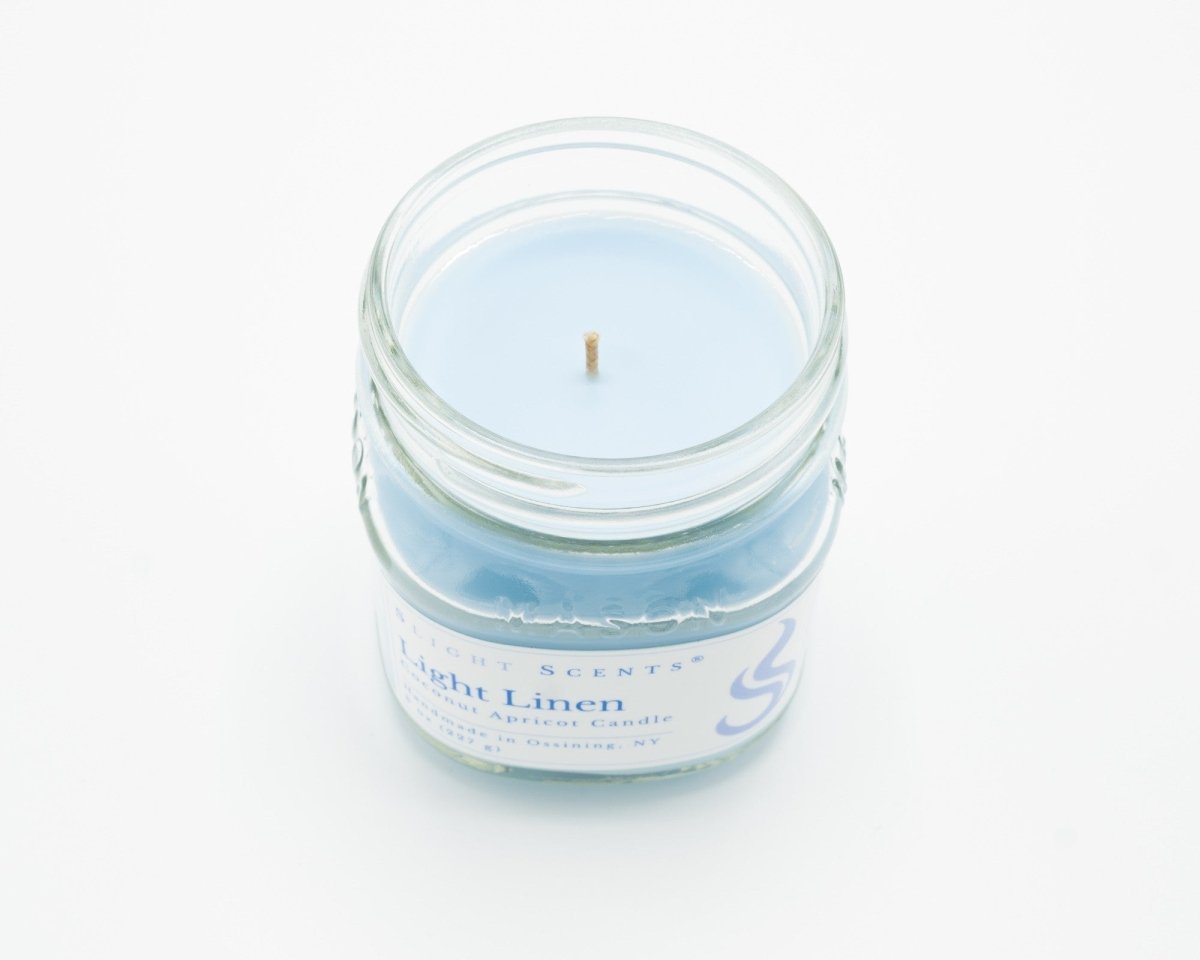 Light Linen Coconut Apricot Candle in a 8oz mason jar without a lid. 