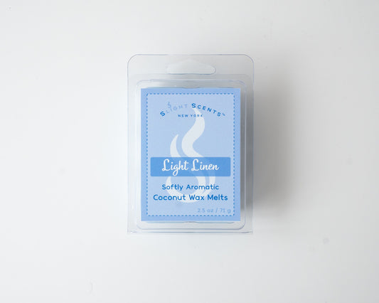 Light Linen wax melt on a white background. Closed clam shell container.