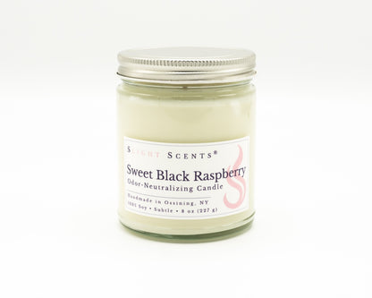 An 8 oz 100% soy candle in a clear glass jar with a silver metal lid, featuring a white label. Slight Scents Sweet Black Raspberry scented odor-neutralizing candle. Handmade in Ossining, NY. 