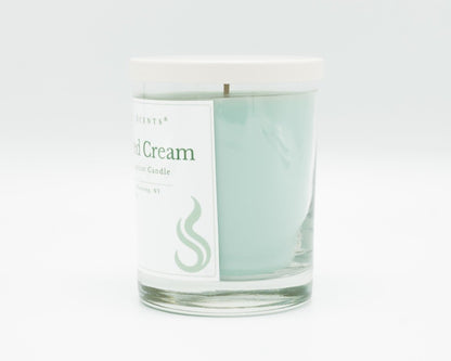 10.5oz Spiced Cream Softly Aromatic Coconut Apricot Candle by Slight Scents, handcrafted in New York. Side photo on a white background with a white lid.