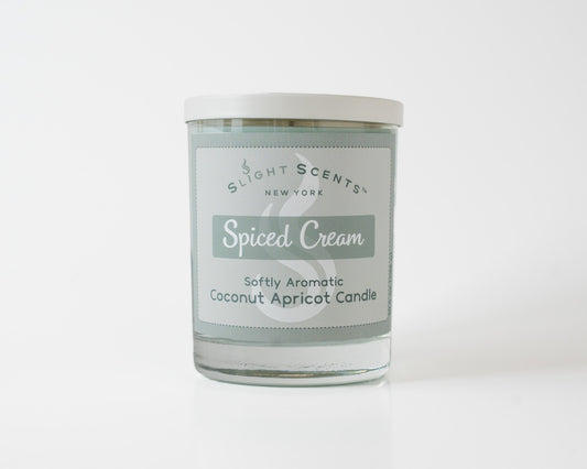 Spiced Cream Softly Aromatic Coconut Apricot Candle by Slight Scents New York against a white background.