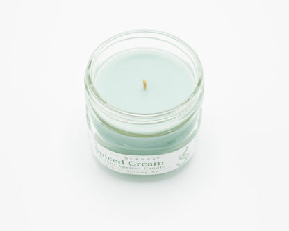 Spiced Cream Coconut Apricot Candle in a 4.5oz mason jar without a lid.