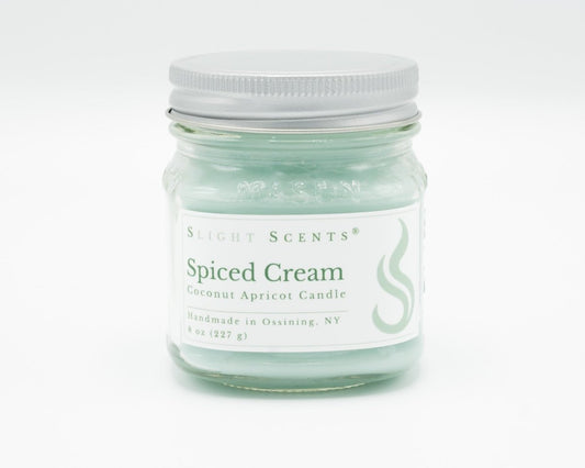 Spiced Cream Coconut Apricot Candle in a 8oz mason jar. Front view.