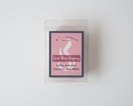 Sweet Black Raspberry wax melt on a white background. Closed clam shell container.