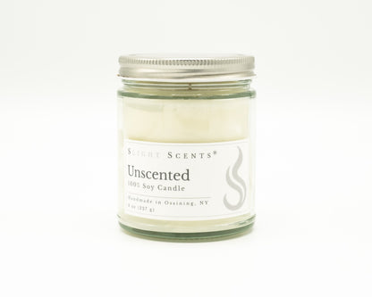 Front view of an unscented soy candle with white label, undyed wax, and silver metal lid in a glass jar. 