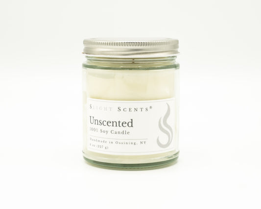 Front view of an unscented soy candle with white label, undyed wax, and silver metal lid in a glass jar. 