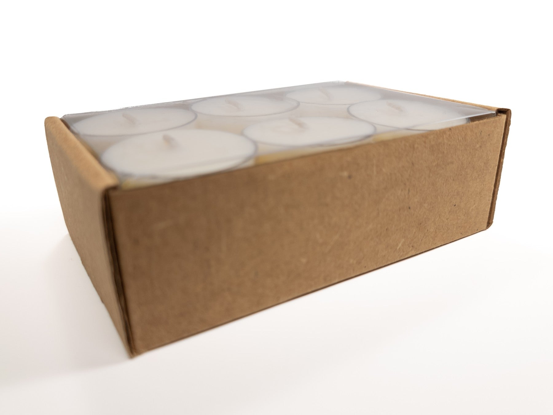 A 12-pack of 100% soy tealights neatly arranged in a cardboard box with a clear plastic cover, showcasing the tealights inside. 6.8oz 194g.