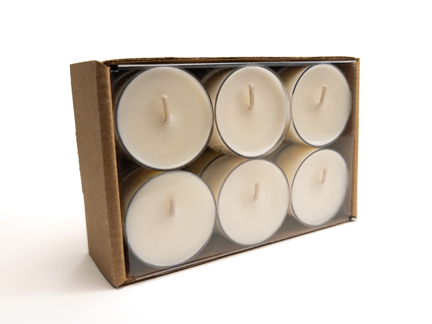 A 12-pack of 100% soy tealights neatly arranged in a cardboard box with a clear plastic cover, showcasing the tealights inside. 6.8oz 194g. Box turned on its side.