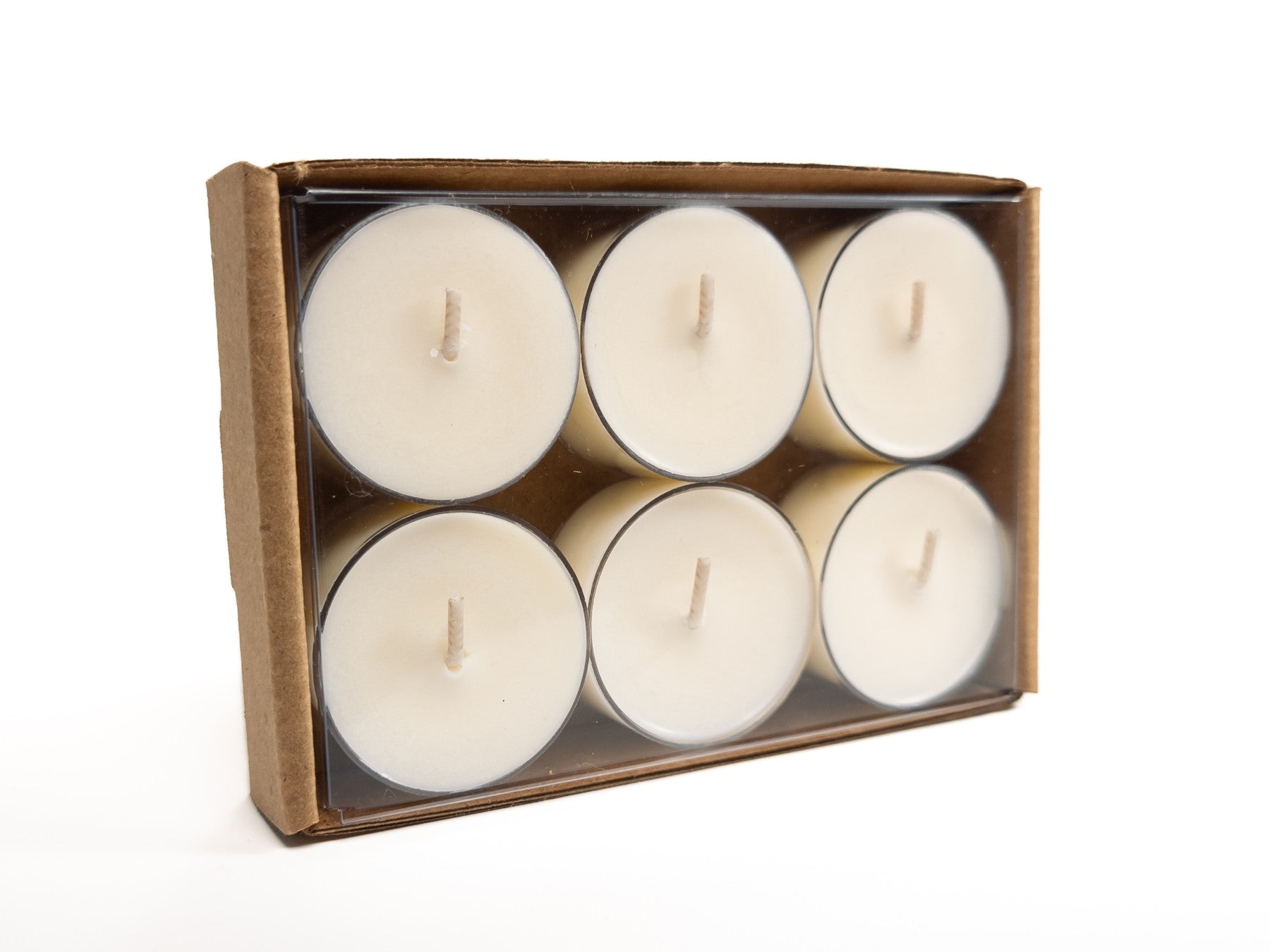 A 6-pack of 100% soy tealights neatly arranged in a cardboard box with a clear plastic cover, showcasing the tealights inside. 3.42oz / 97g. Box turned on its side.